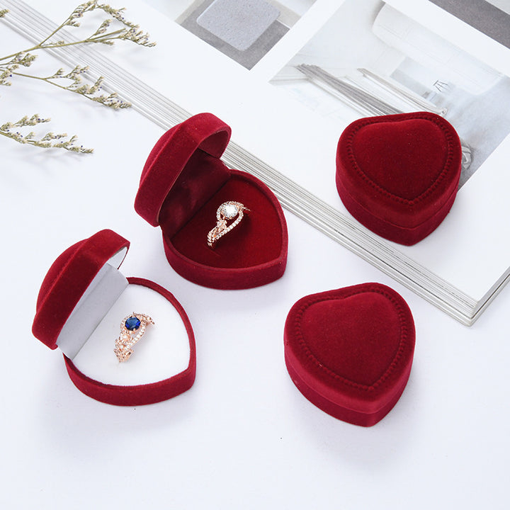 Heart-shaped velvet ring box with cushioned white interior and secure ring slot Bowlift