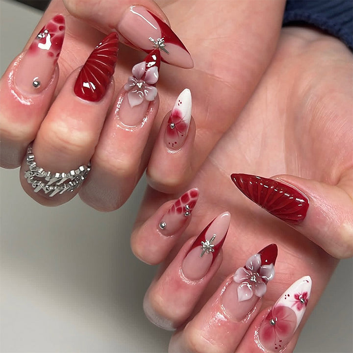 Artificial nail set with glamorous floral designs and creative glitter accents Bowlift