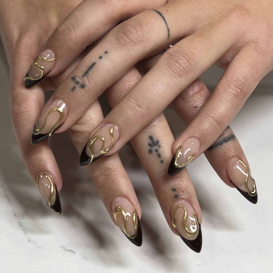 Artful stiletto nails with elegant gold design Bowlift