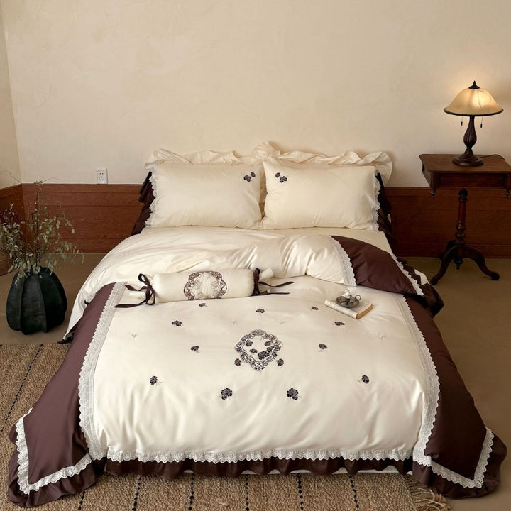 Luxurious embroidered bedding set with ruffle and decorative roll Bowlift