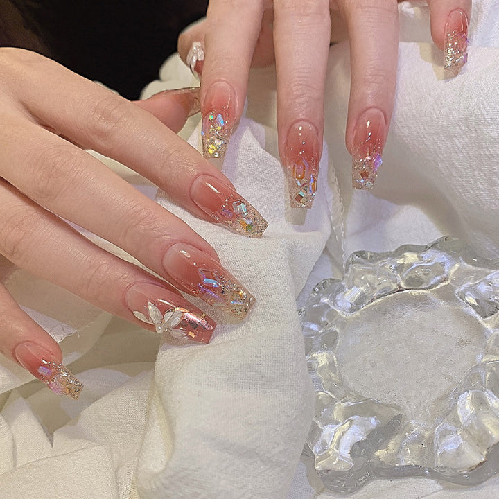 Artificial nail set with floral and glittering accents Bowlift