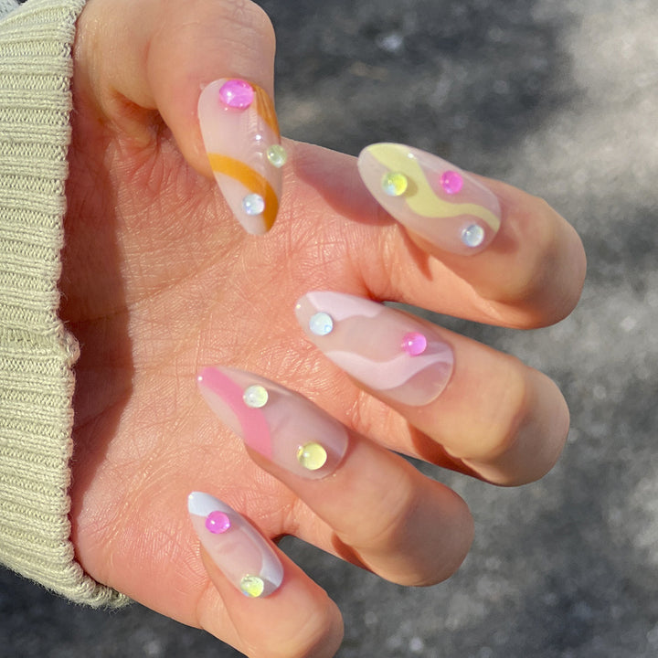 Artistic Nail Extensions with Colorful Design and Glitter Accents Bowlift