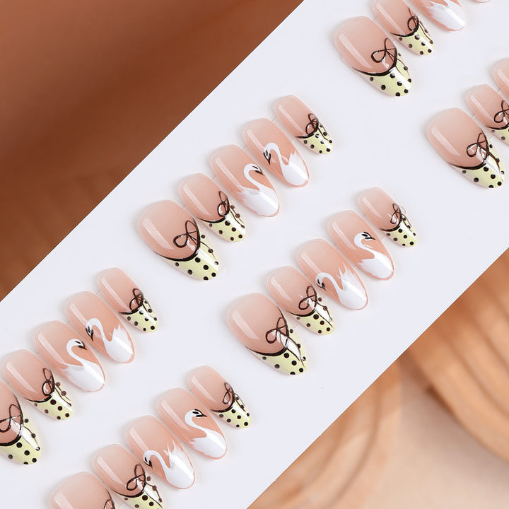 Art nail set with creative swan design and playful dots Bowlift