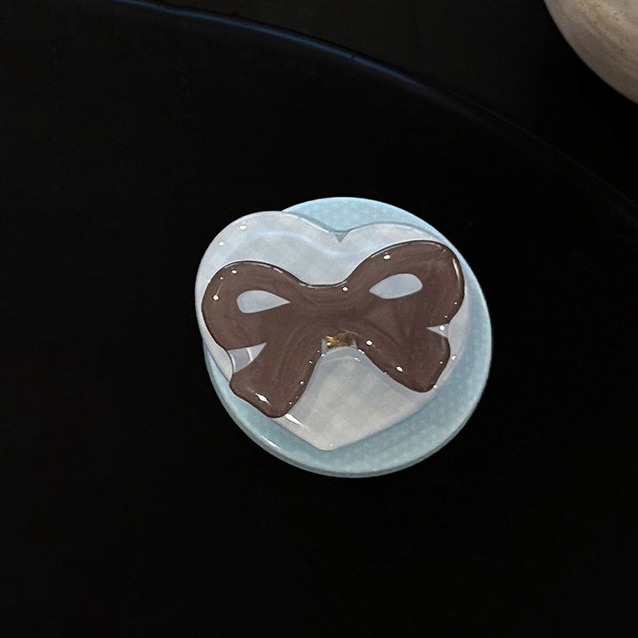 Decorative ceramic coaster with bow motif Bowlift