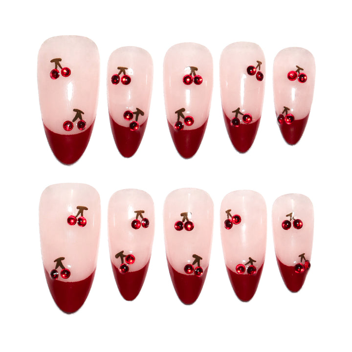 Artful stiletto nails with cherry motifs and glitter accents Bowlift