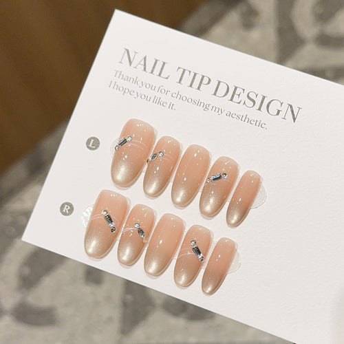 Artificial nail tips with elegant gradient color and rhinestone accents Bowlift
