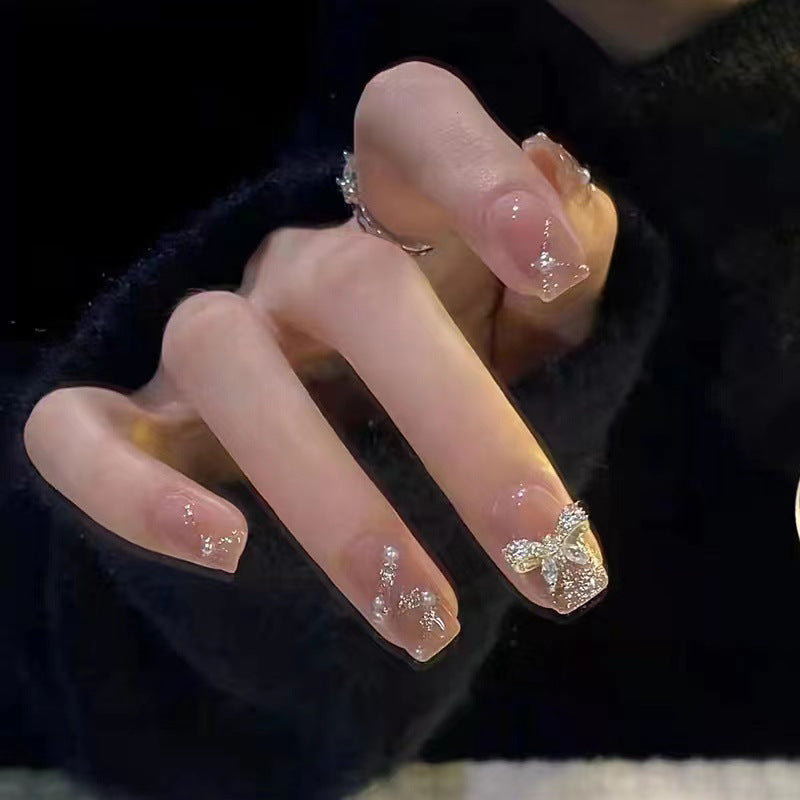 Artificial nails in an elegant design with 3D butterflies and glitter accents Bowlift