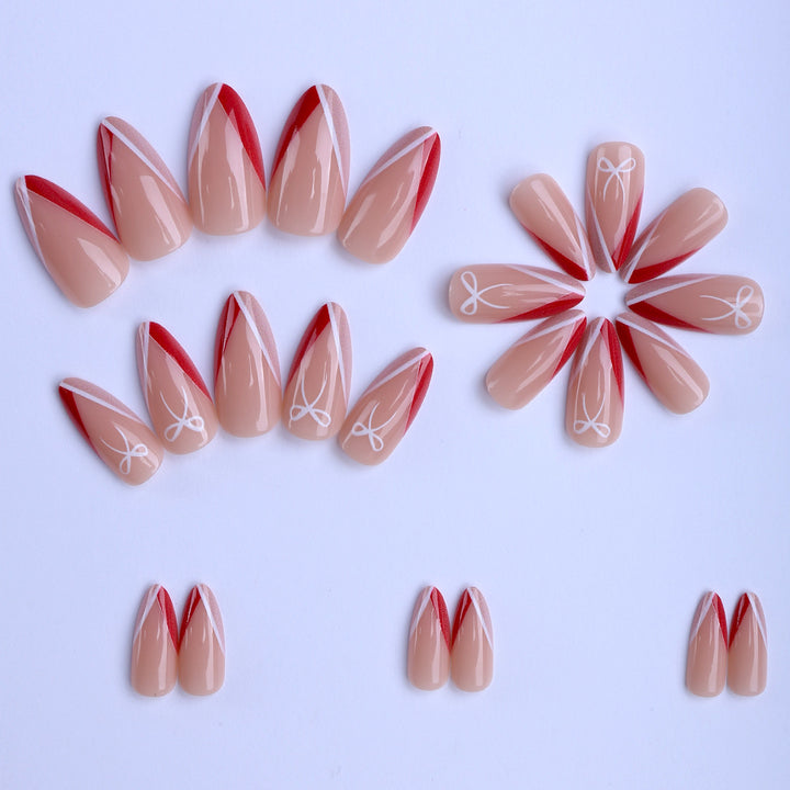 Artificial nails in elegant stiletto design with bow accents Bowlift