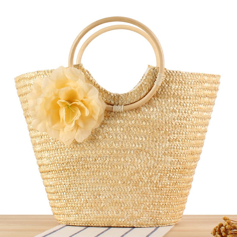 Braided straw bag with floral accent Bowlift