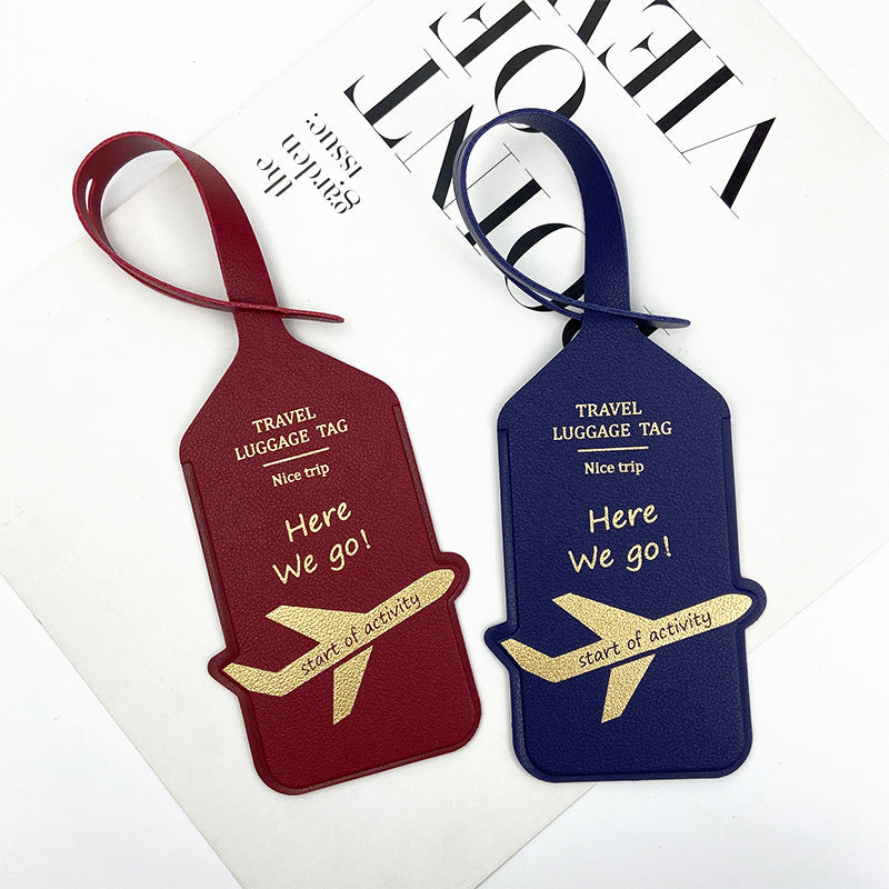 premium leather travel luggage ID tag with embossed airplane motif and adjustable strap Bowlift