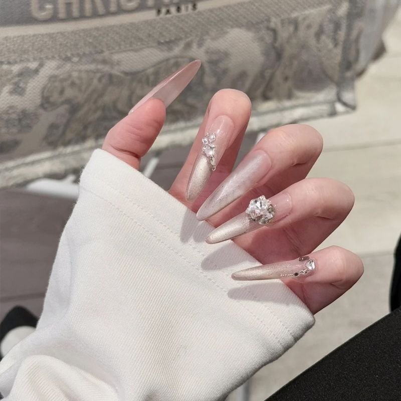 Acrylic nail set with elegant tips and glamorous rhinestone accents Bowlift