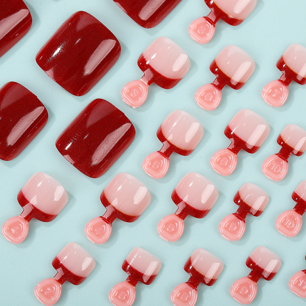 Acrylic nail set in elegant red and nude design Bowlift