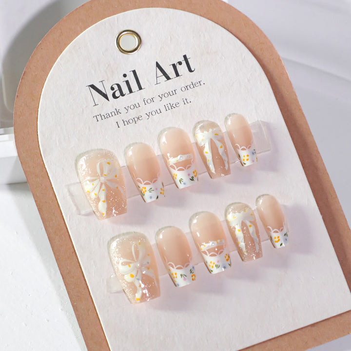 Artful Nail Extensions with Floral Design and Bow Accents Bowlift