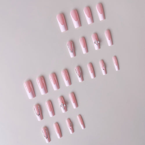 Acrylic nail set with glamorous rhinestone decorations and elegant French tips Bowlift