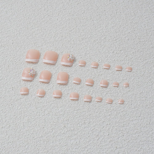 Artificial nail set with elegant French tip design and sparkling accents Bowlift
