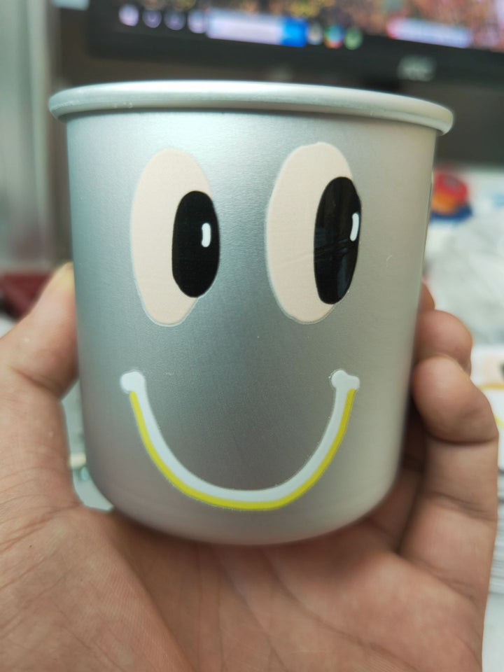 insulated stainless steel smiley-face cup with reusable lid non-slip base and kid-friendly grip Bowlift