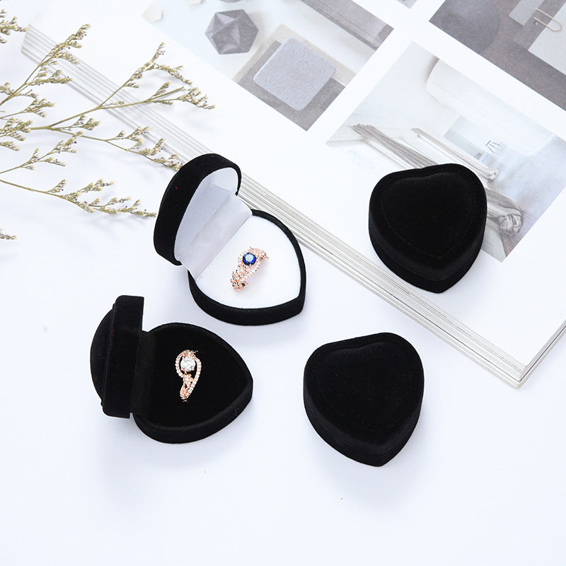 Heart-shaped velvet ring box with cushioned white interior and secure ring slot Bowlift