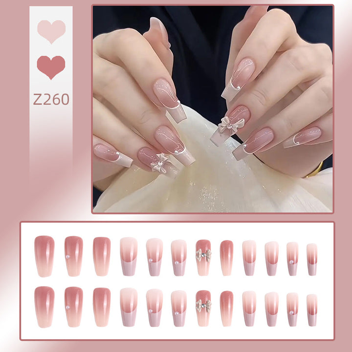 Artificial nail set with elegant ombre design and delicate bow embellishments Bowlift