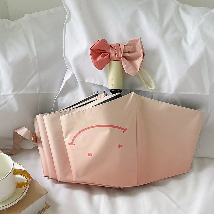 Women's foldable umbrella with playful design and handy wooden handle Bowlift