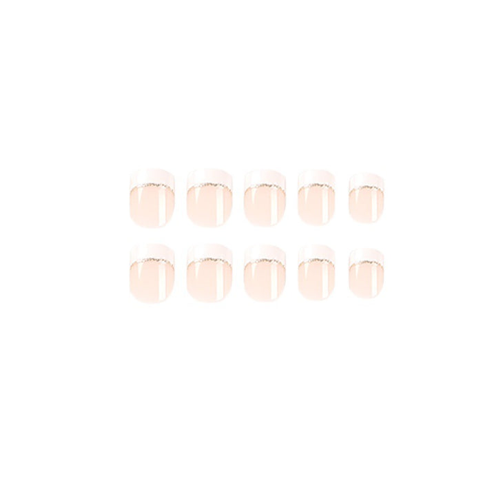 Artful nail extensions with elegant French tip and gold accents Bowlift