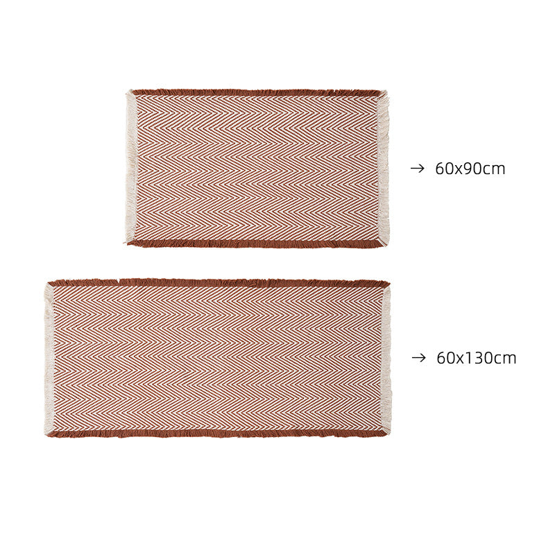 Handwoven cotton bath mat with herringbone pattern and fringes Bowlift