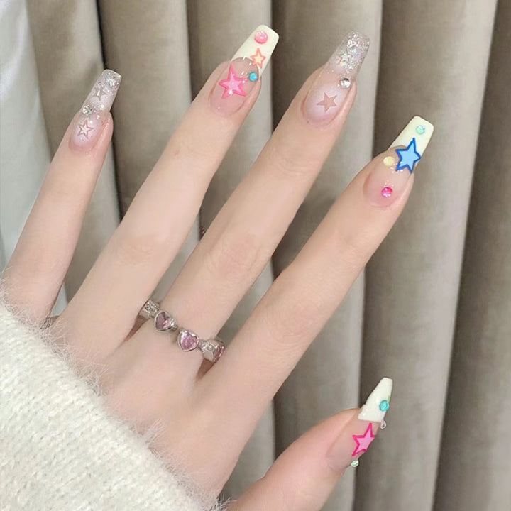 Glamorous artificial nails with heart design and glittering accents Bowlift