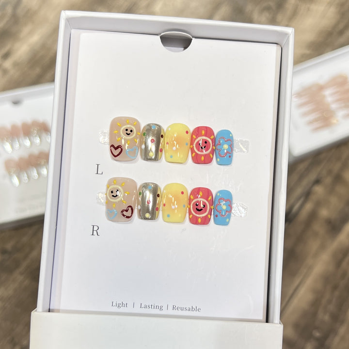 Whimsical Press-On Nail Art Set with Smiley Faces and Floral Designs Bowlift