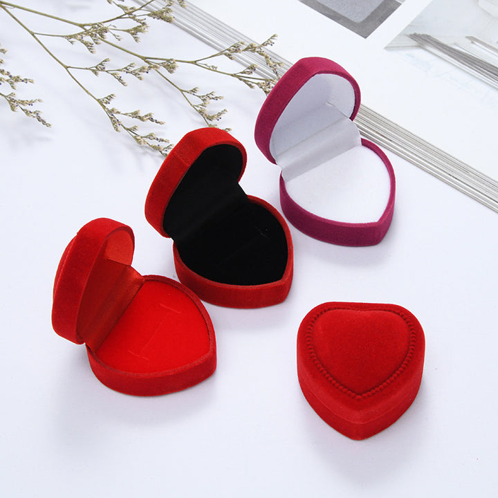 Heart-shaped velvet ring box with cushioned white interior and secure ring slot Bowlift