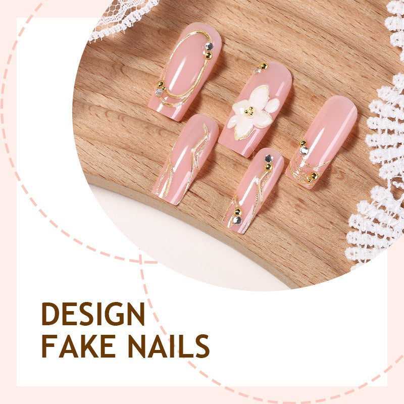 Elegant artificial nail set with decorative flower and gold embellishments Bowlift