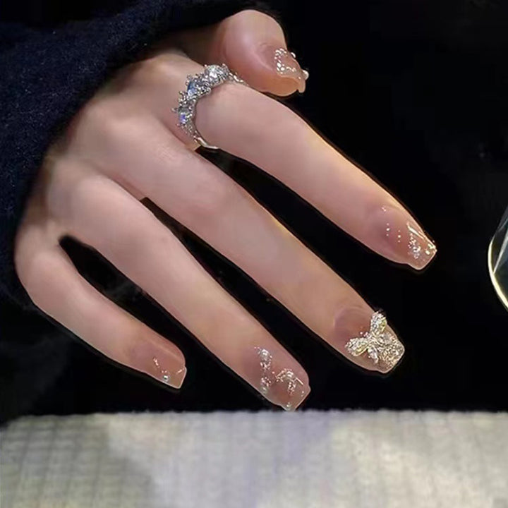 Artificial nails in an elegant design with 3D butterflies and glitter accents Bowlift