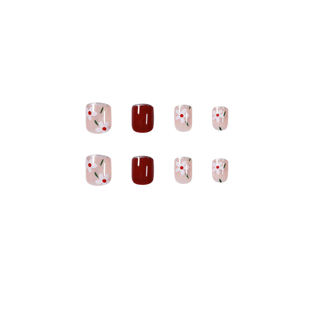 Artful nail art with floral motifs and glitter accents Bowlift
