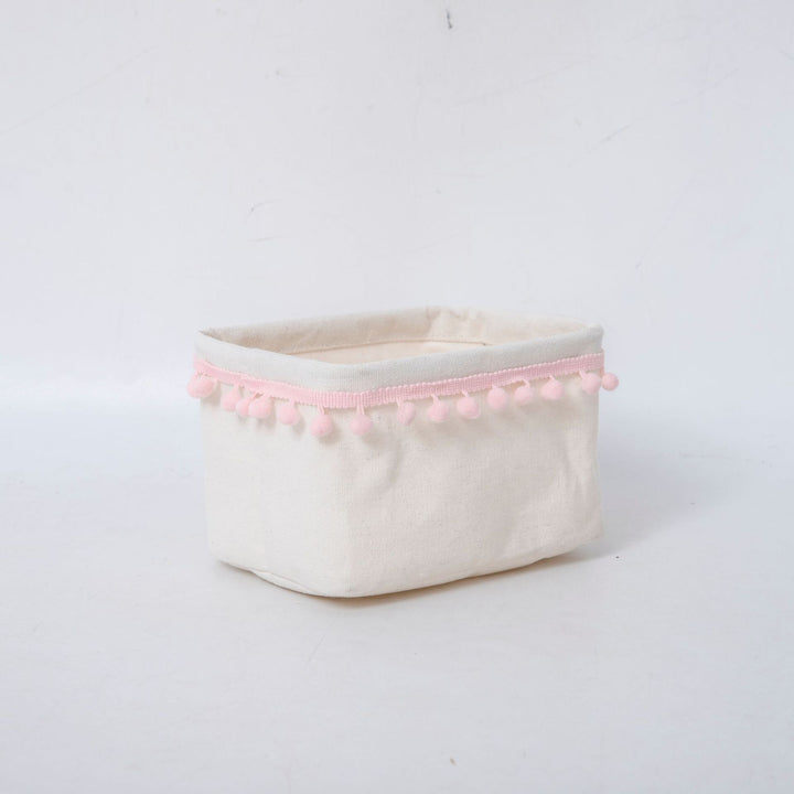 Storage basket with decorative pom-pom trim