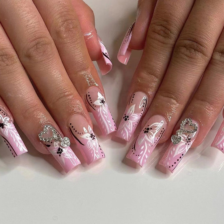 Artistic nail art with flower and heart motifs Bowlift