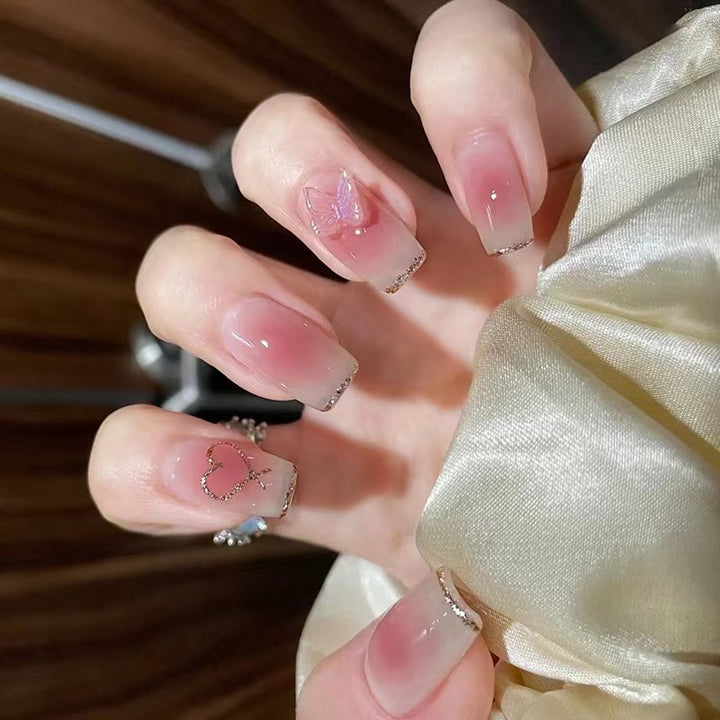 Artistic acrylic nails with heart and butterfly motifs Bowlift