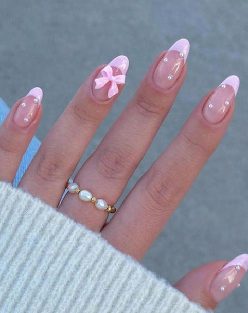 Artificial nail set with shimmering 3D bows and elegant pearl accents Bowlift