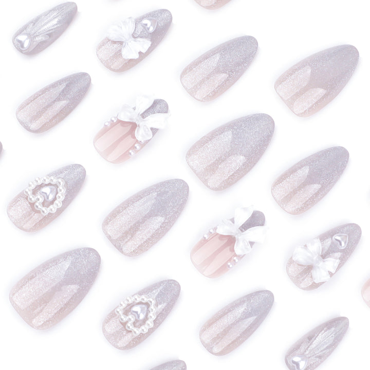 Artful nail decoration with pearl and bow accents Bowlift