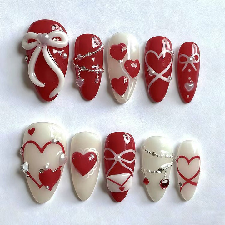 Glamorous artificial nail set with romantic heart design and elegant embellishments Bowlift