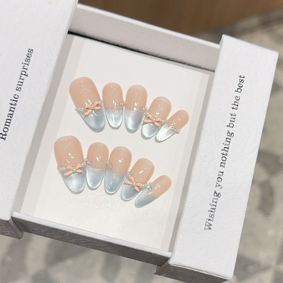 Artificial nail set with romantic bow and glitter accents Bowlift