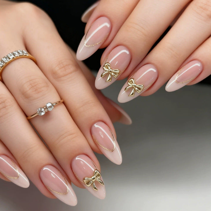 Creative Stiletto Nail Set with Gold Accents and Transparent Finish Bowlift