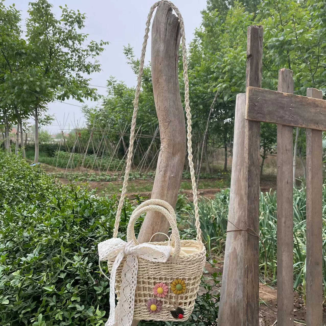 Playful basket bag with floral appliqués Bowlift