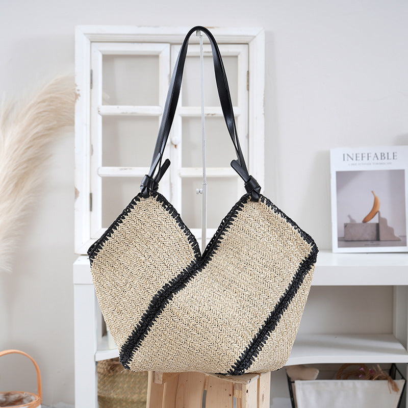 Handbag made of braided natural material with contrasting leather handles Bowlift
