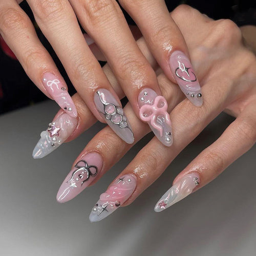 Artful stiletto nails in an elegant design with creative embellishments Bowlift