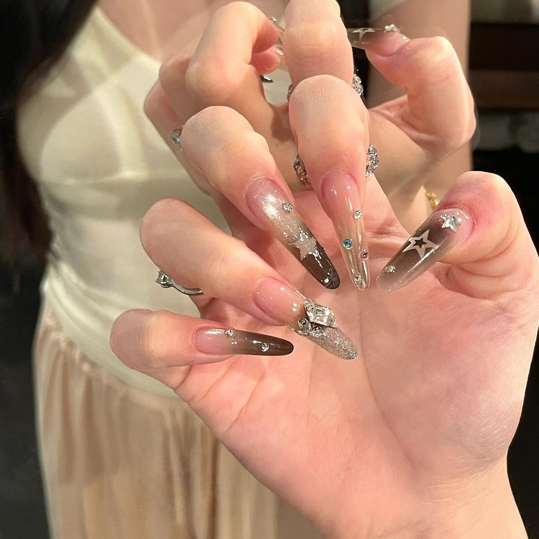 Glamorous artificial nails with sparkling rhinestone and star designs Bowlift