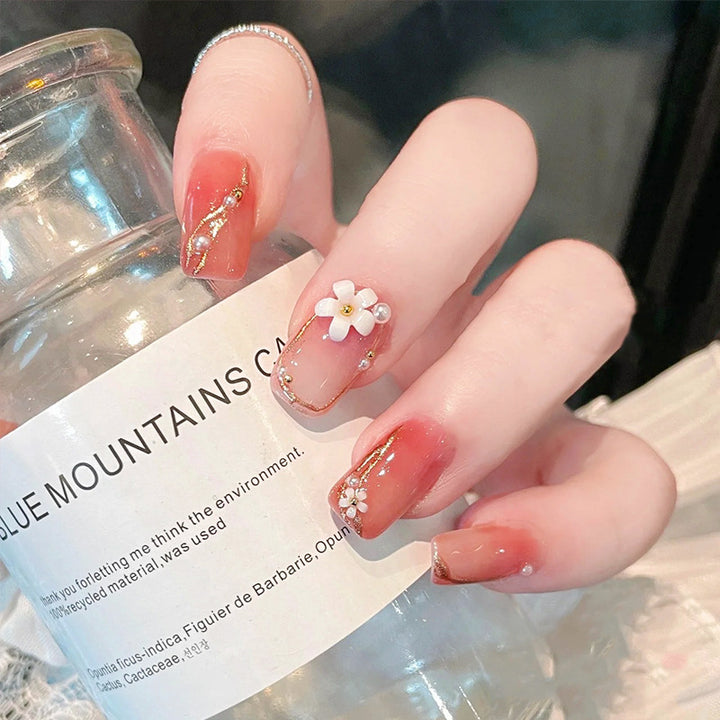 Acrylic nail set with elegant floral decorations and glamorous pearl accents Bowlift