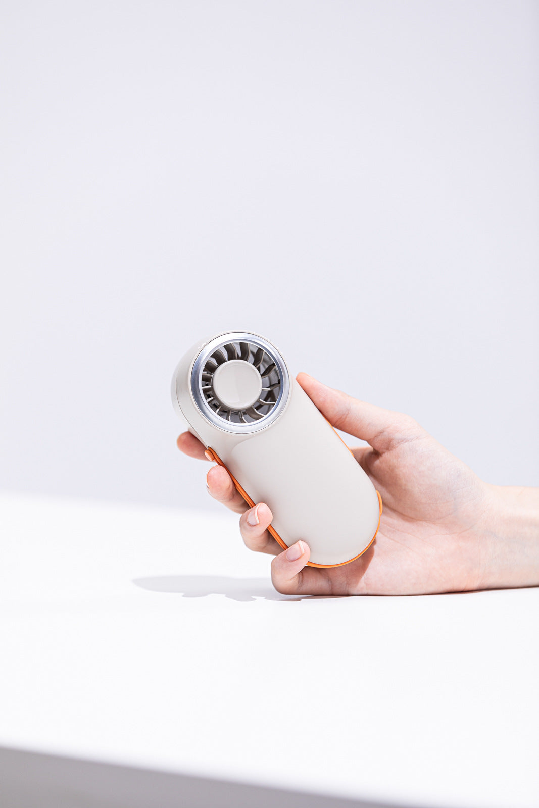 Unisex nan compact rechargeable handheld fan with ergonomic grip and carrying strap Bowlift