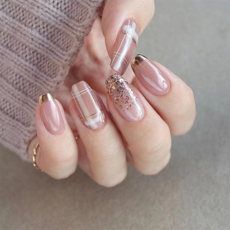 Artistic Nail Extensions with Glitter and Gold Accents Bowlift