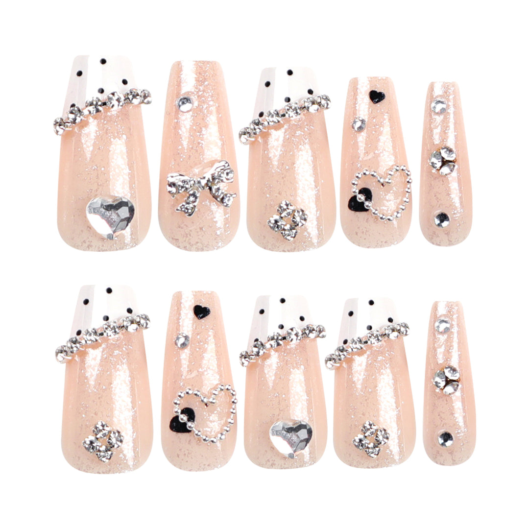 Artful nail extensions with elegant rhinestone and heart designs Bowlift