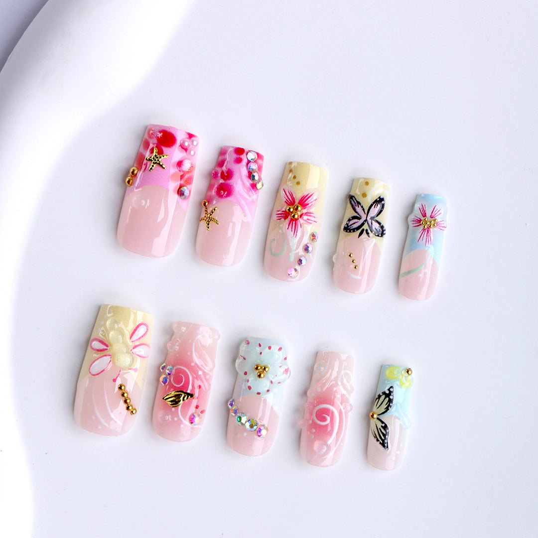 Artistic nails with floral accents and glitter clusters Bowlift