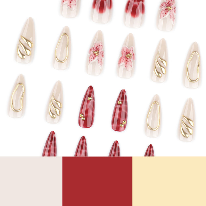Artful stiletto nails with elegant floral designs and glitter accents Bowlift