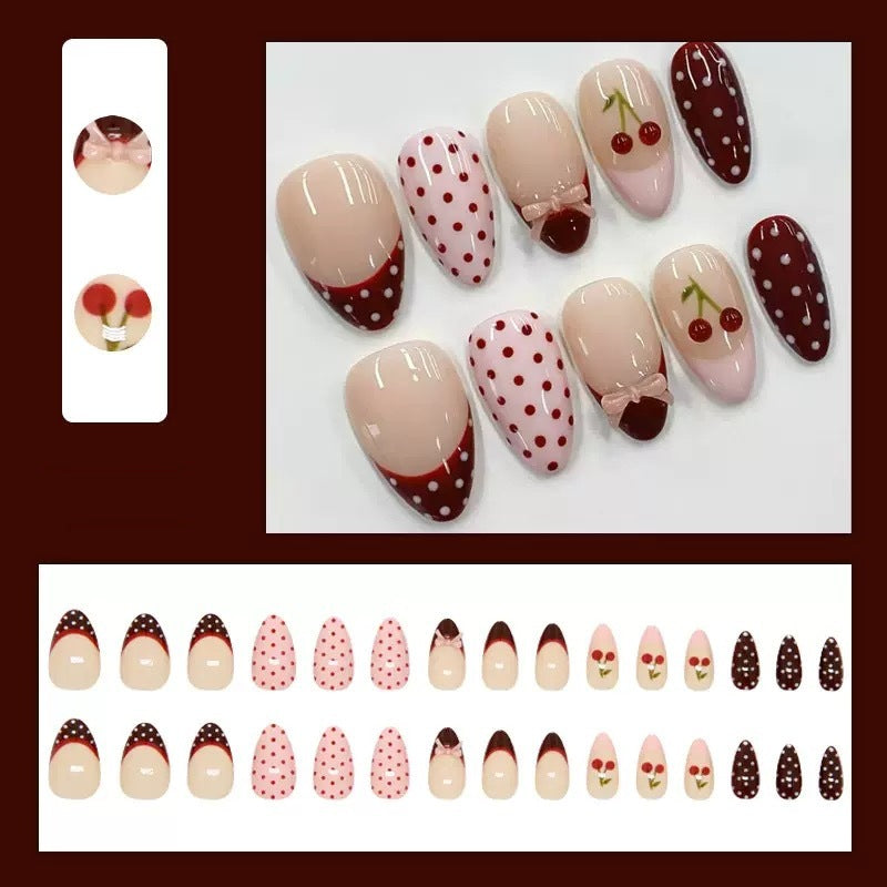 Artfully designed nail tips with cherry and dot motifs Bowlift